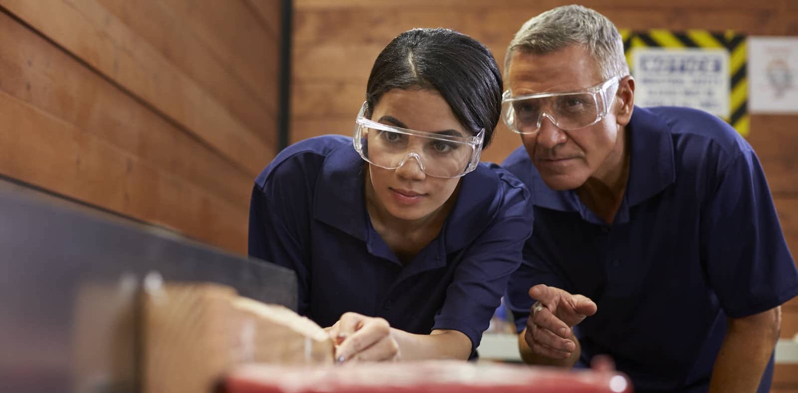 Modern high school shop classroom - student and teacher